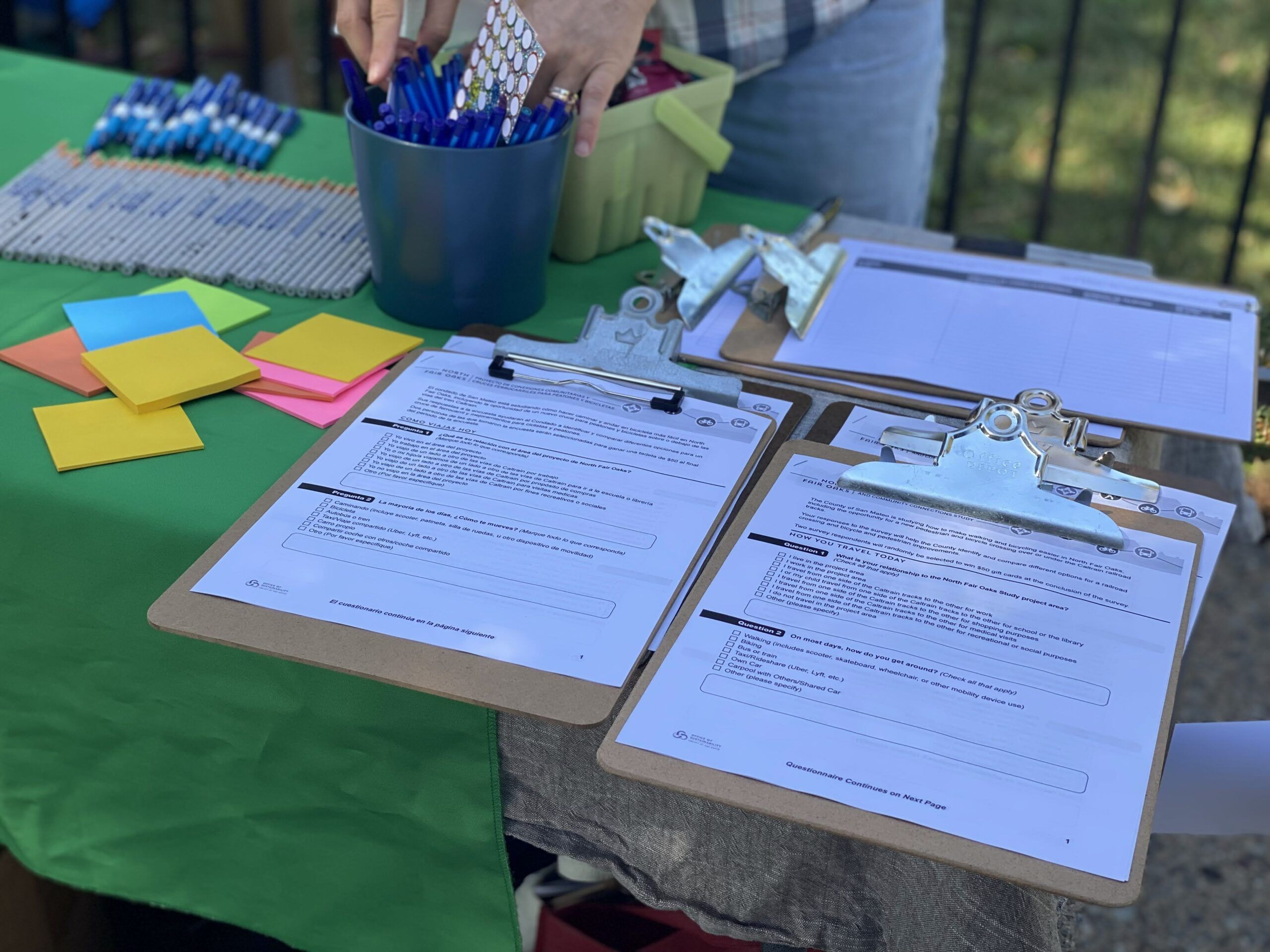Table outside wiht clipboards and note papers for community members to share their feedback