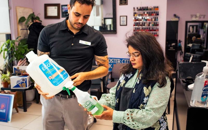 woman owner of My Fair Lady salon discusses eco-friendly cleaning products with California Green Business Network staff