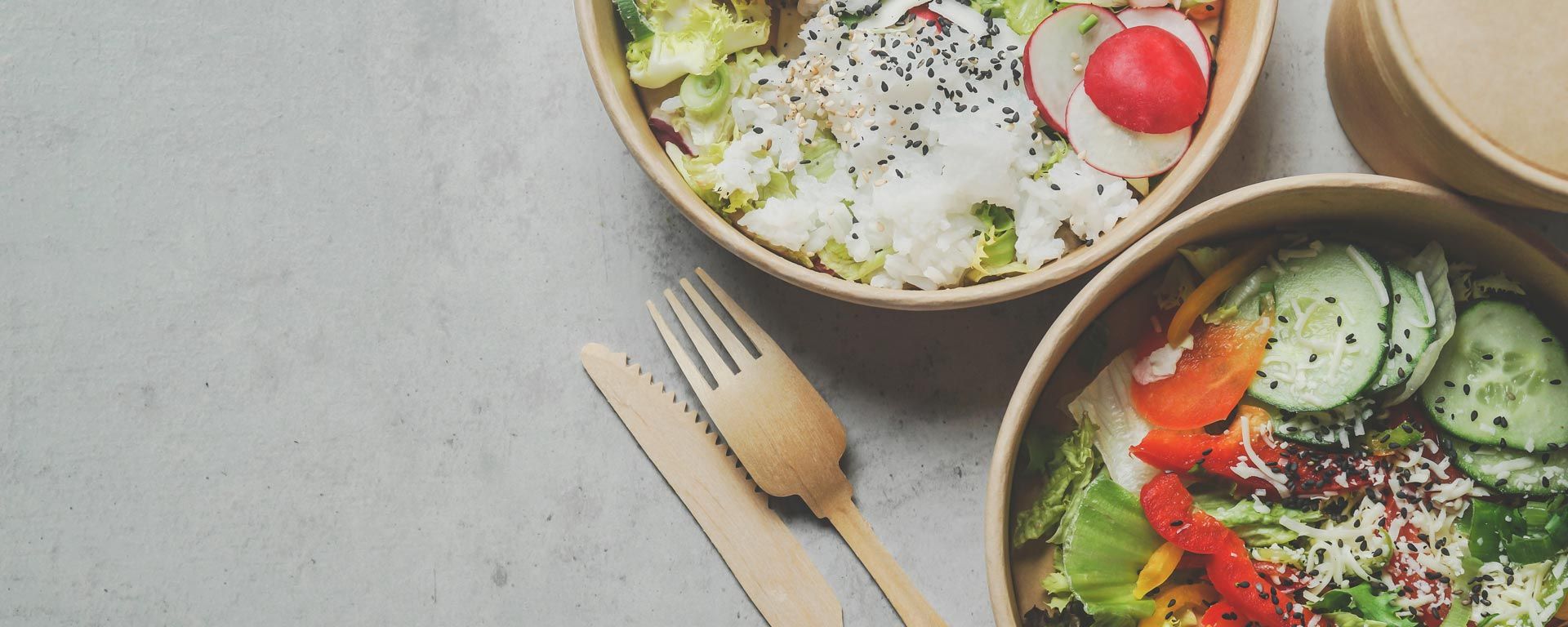 food served in compostable takeout bowls and bamboo fork and knife