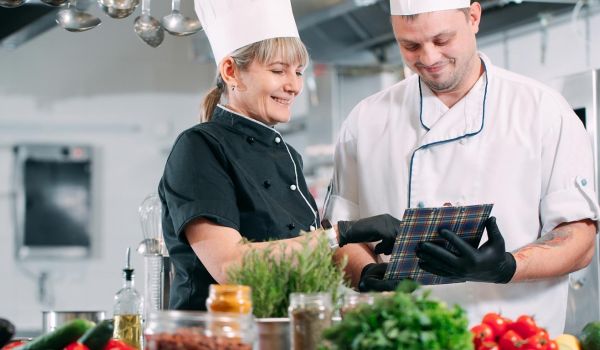 restaurant workers addressing food waste prevention