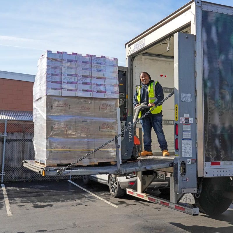 truck driver unloading pallet of recovered food