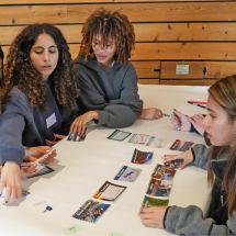 Youth Climate Ambassador Leadership Program students working together at a table with cards for climate activity