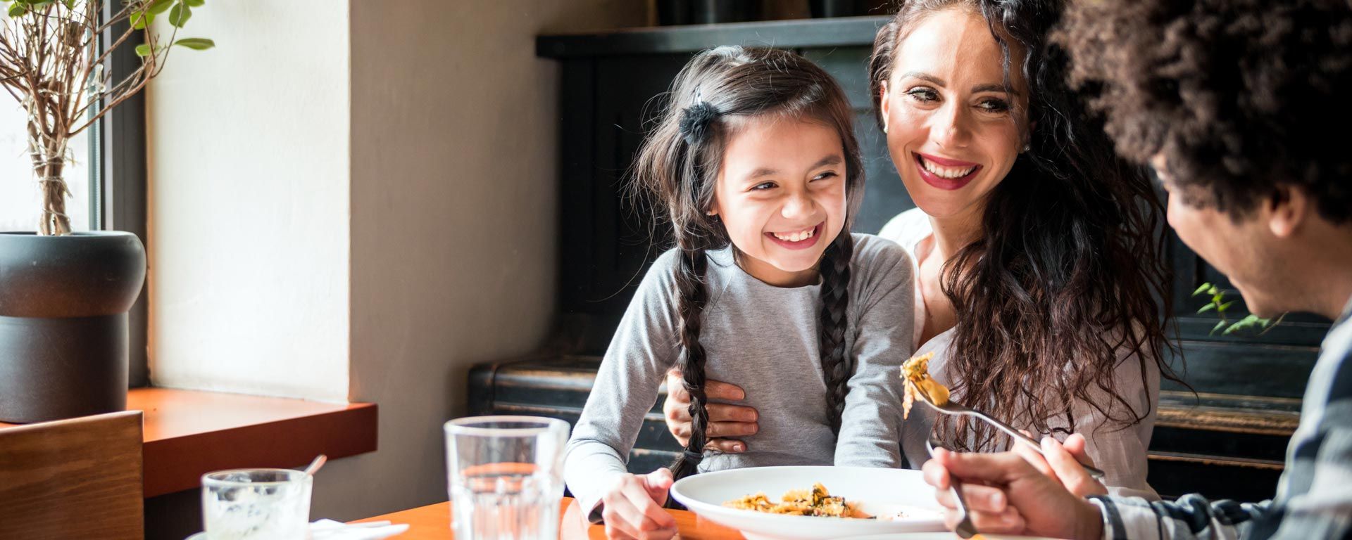 young family eating dinner at a restaurant