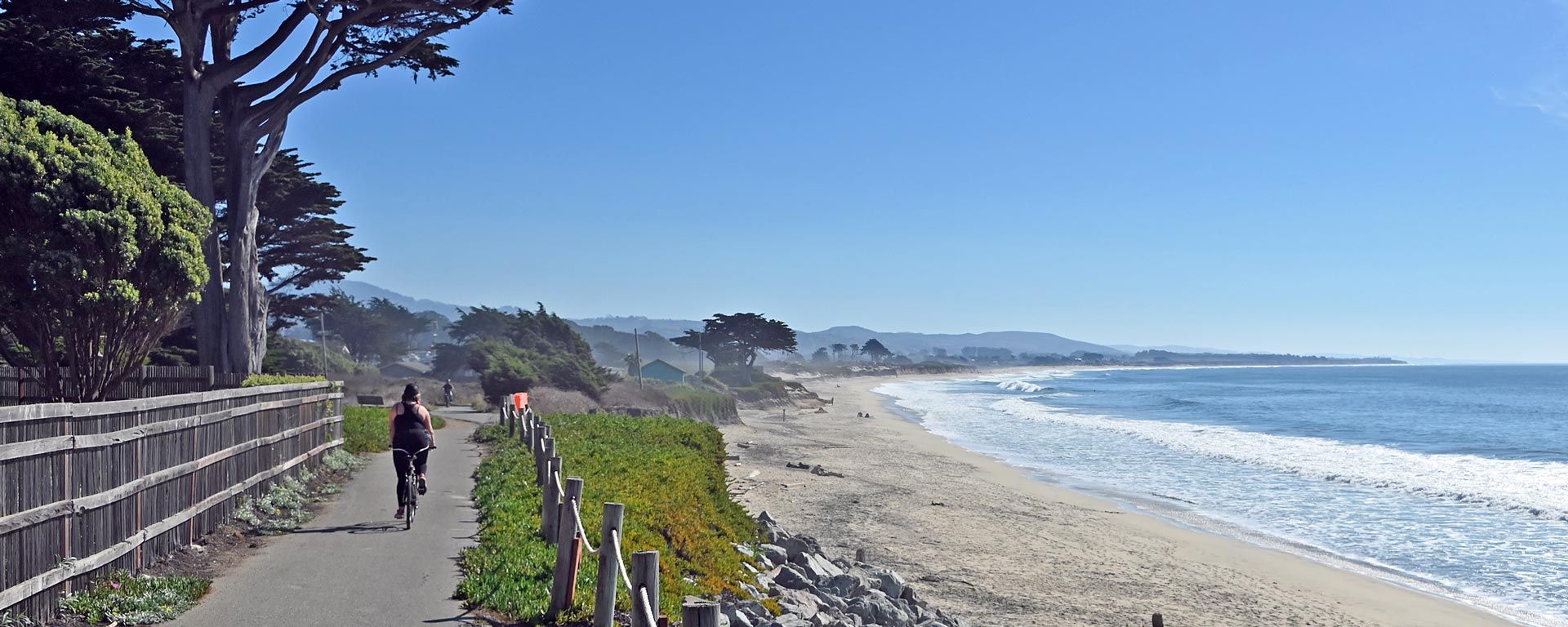 bike riders on coastal trail in Half Moon Bay on a sunny day