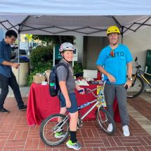 boy on bicycle at San Mateo County Sustainability Department Bike to Wherever Day booth