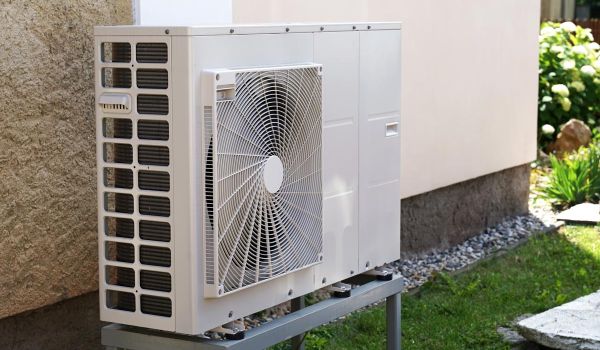 electric heat pump installed outside of a house