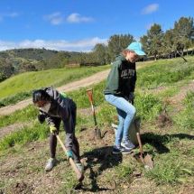 two Youth Climate Ambassador Leadership Program students working on a pollinator garden as a community impact project
