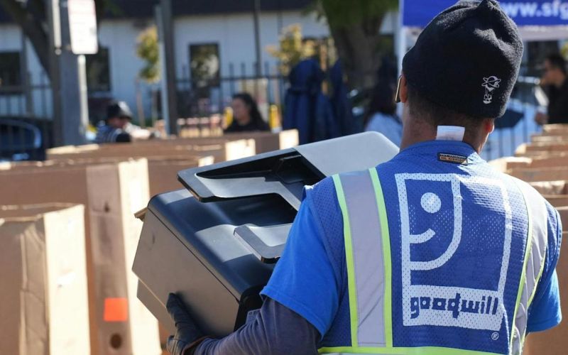 Goodwill employee sorts donated electronic waste in Public Works Yard in Redwood City, September 2024