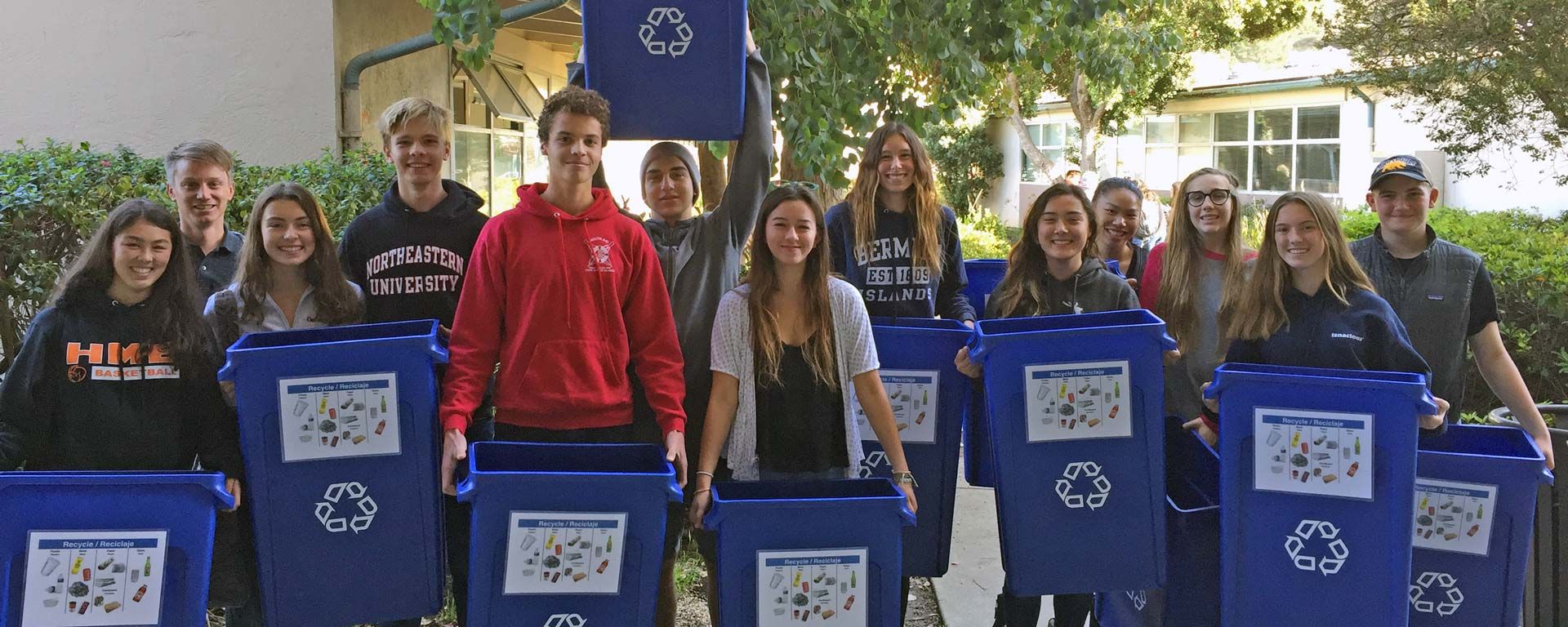 Environmental Club students holding recycling bins