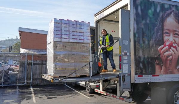 truck driver unloading pallet of recovered food