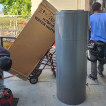 technicians deliver and install hybrid hot water heater at San Mateo County facility