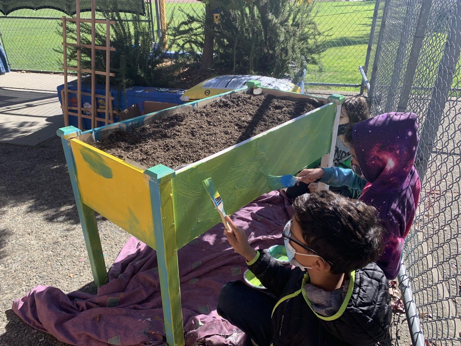 Planter bed being painted during educational worksho