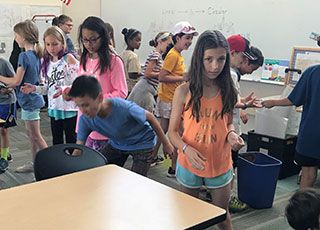 students playing recycling relay