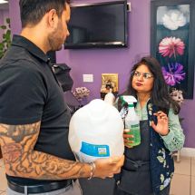 two people looking at laundry detergent and all purpose cleaner used in restaurant