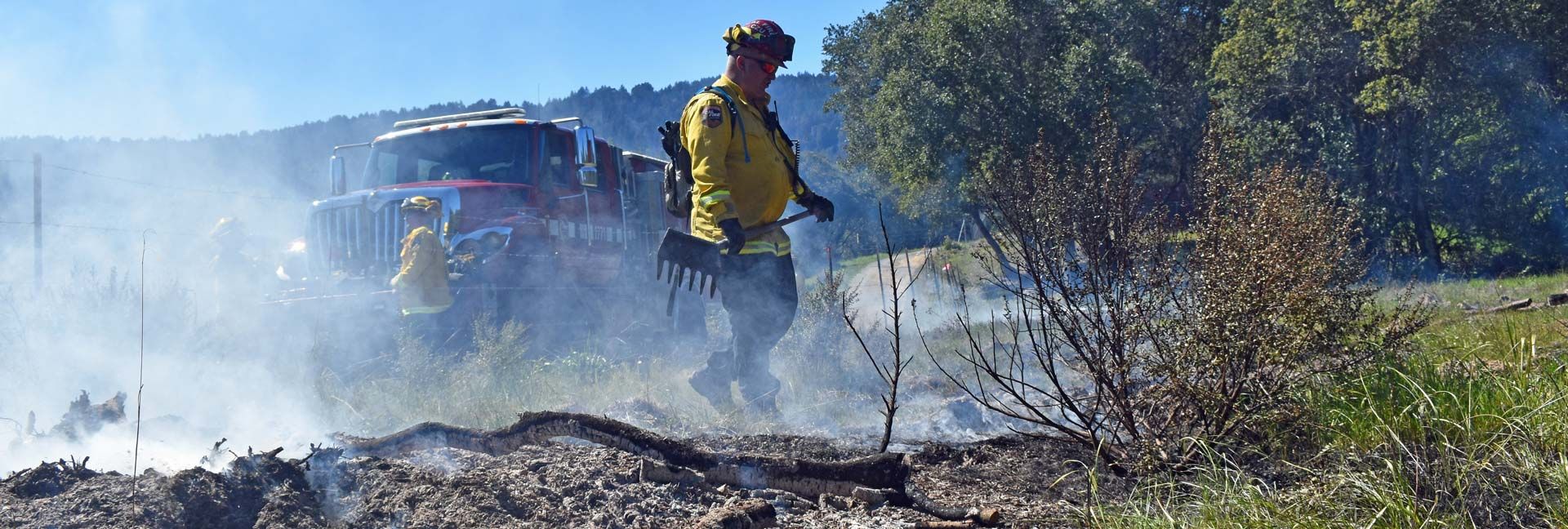 firefighters mopping up grass wildfire