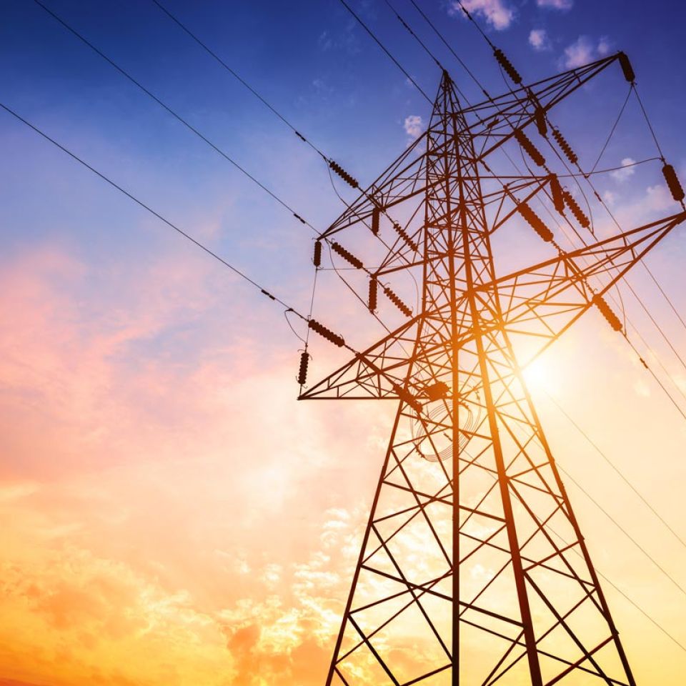 high voltage tower at sunset