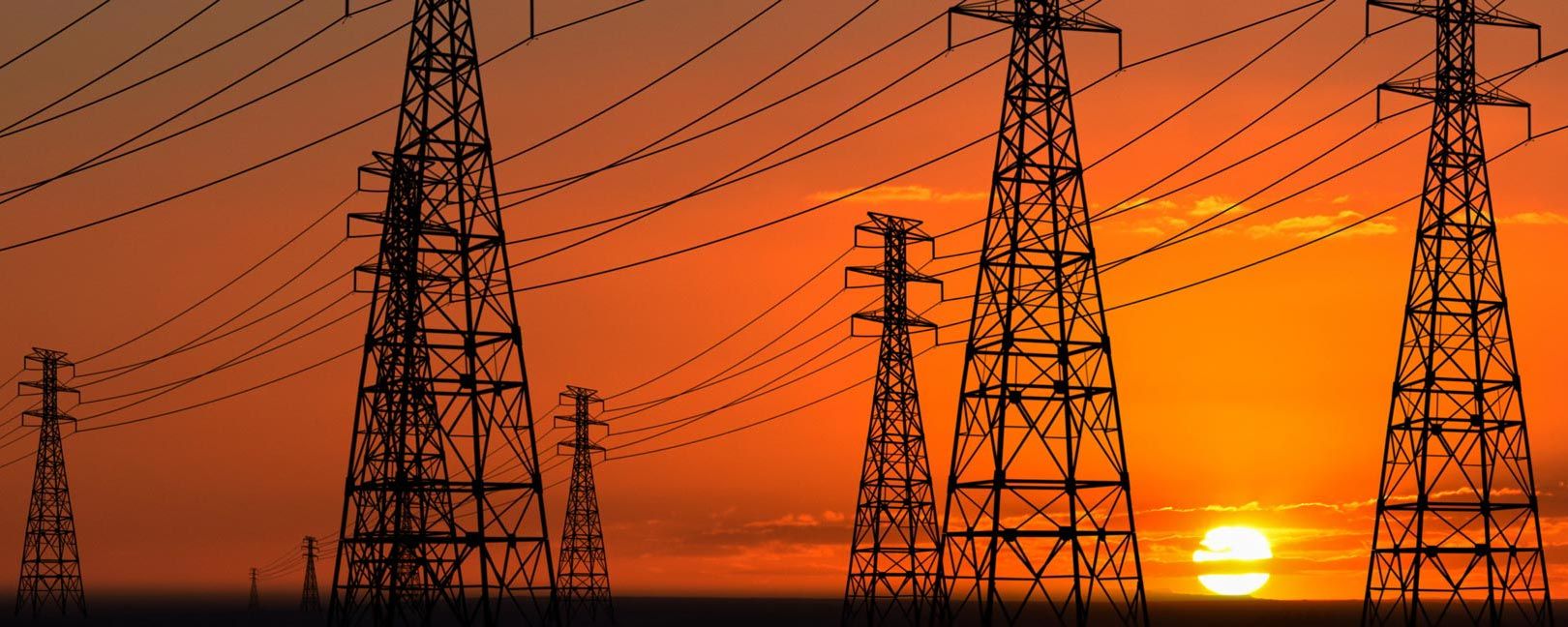 red orange sunset behind power lines