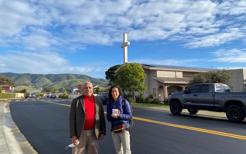 Hope United Methodist Church pastor in front of church with solar panels and other community resilience pilot program improvements