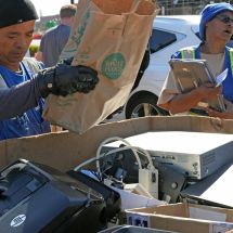 workers sorting electronics for recycling