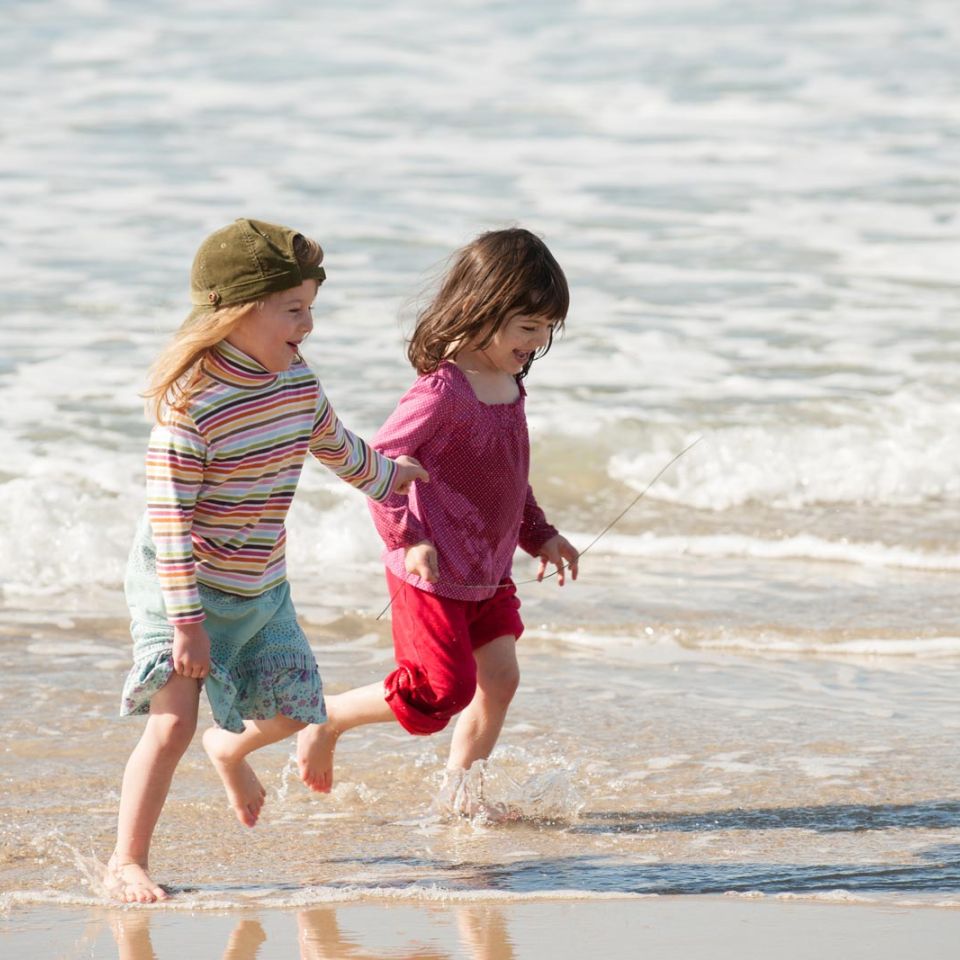 young girls running on the beach benefit from climate action planning