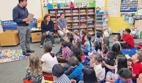 elementary students sitting in a classroom listening to a Solutions to Waste schools program lesson