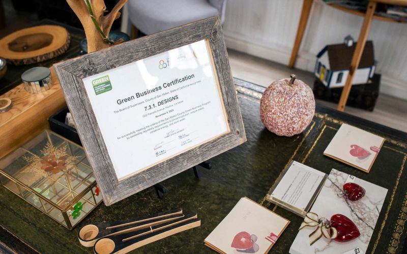 closeup of 7.3.1. Designs Green Business Certification framed award on product display table