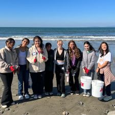 students picking up trash on the beach