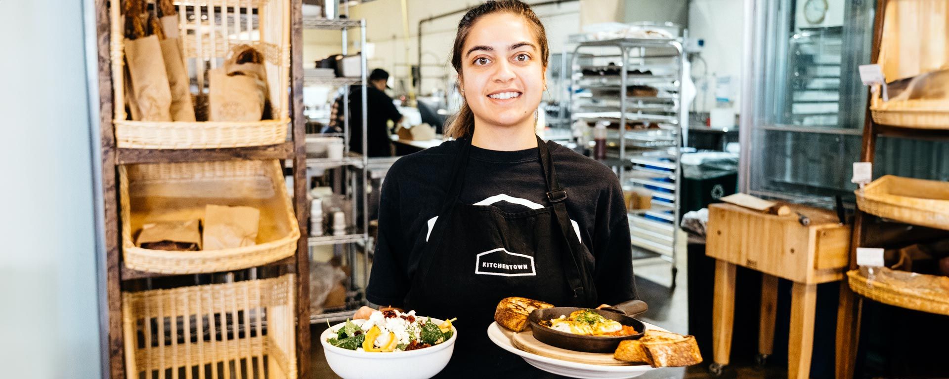 San Mateo County small business restaurant employee serving two plates of food