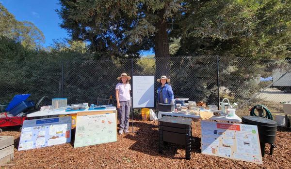 compost workshop instructors with all of their many materials at San Mateo County composting workshop