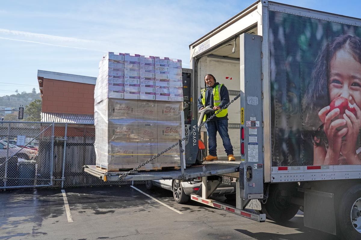 truck driver unloading pallet of recovered food