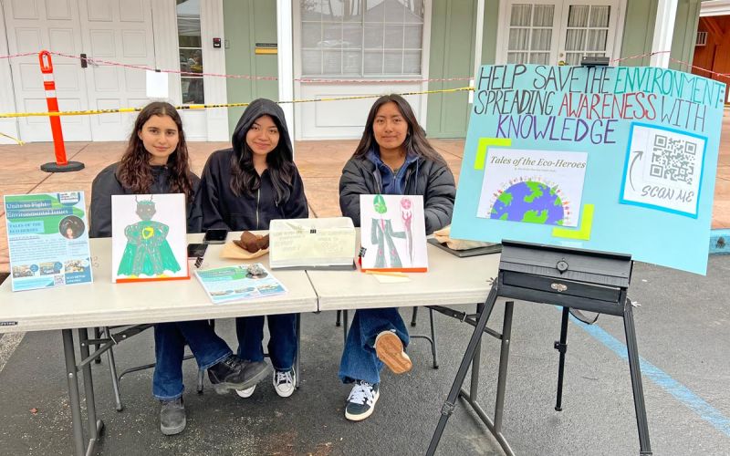 three Youth Climate Ambassador Leadership Program students display their Community Impact Project titled Help Save the Environment by Spreading Awareness with Knowledge