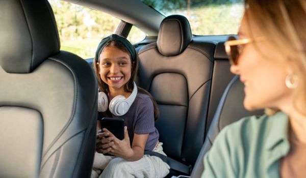 Child smiling inside of electric vehicle