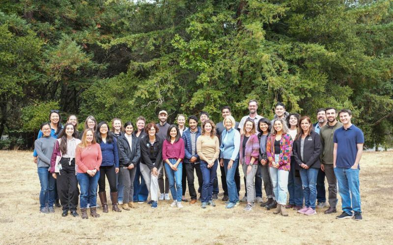 group of Sustainability Department staff stand together in front of trees at a local park