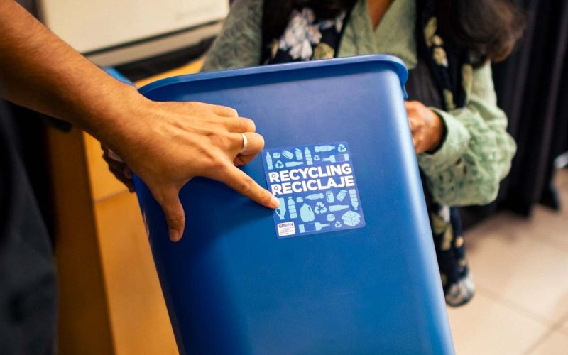 blue recycling bin with label identifying appropriate recyclable items
