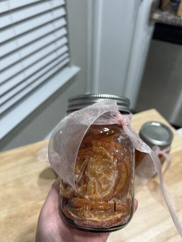 Dried citrus in a glass jar with a bow on it
