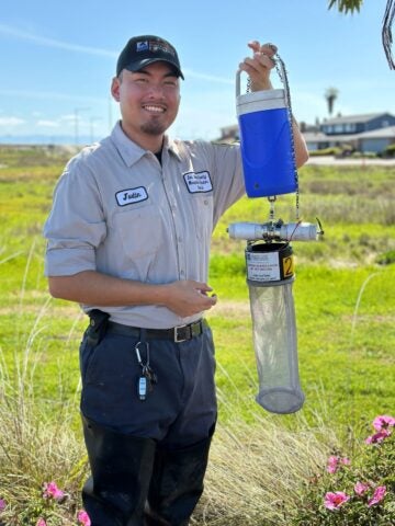 Vector Control Technician Justin, from San Mateo County Mosquito & Vector Control District, holding a mosquito trap. 