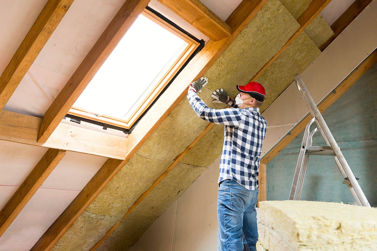 a-man-installing-insulation