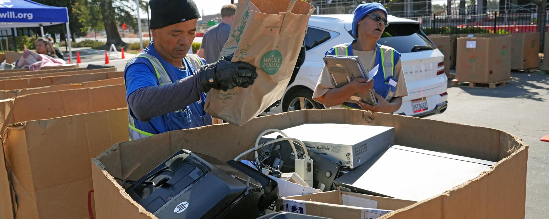 workers sorting electronics for recycling at Goodwill recycling collection event