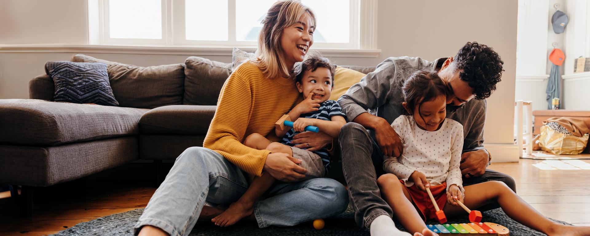 young parents playing with their children at home