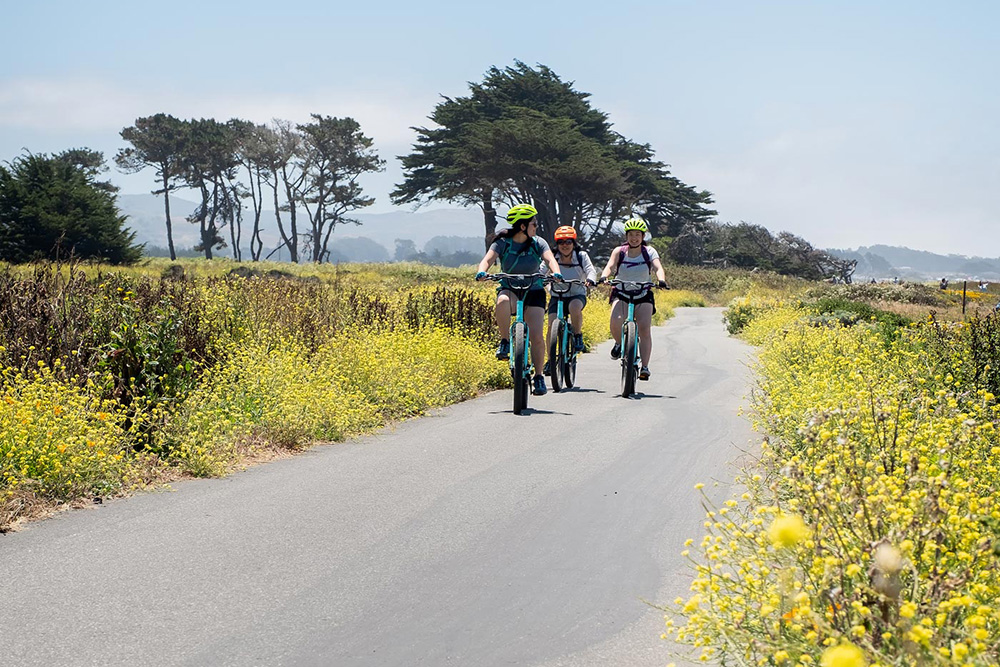 youth climate ambassadors riding bicycles on coastal trail